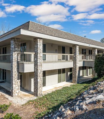 Exterior View Of A Multi-family Residential Building With Stone Accents, Highlighting Available Residential Properties