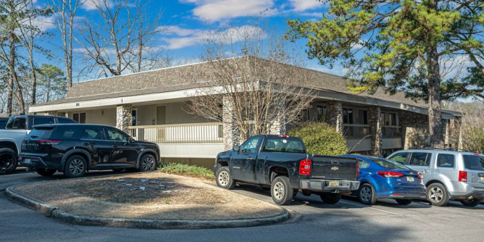 Exterior View Of A Commercial Building Surrounded By Parked Vehicles Representing Available Commercial Real Estate Opportunities