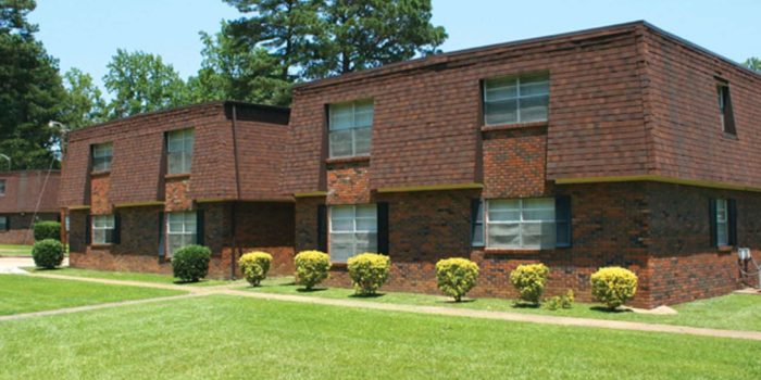 A Large Lawn In Front Of A Brick Building
