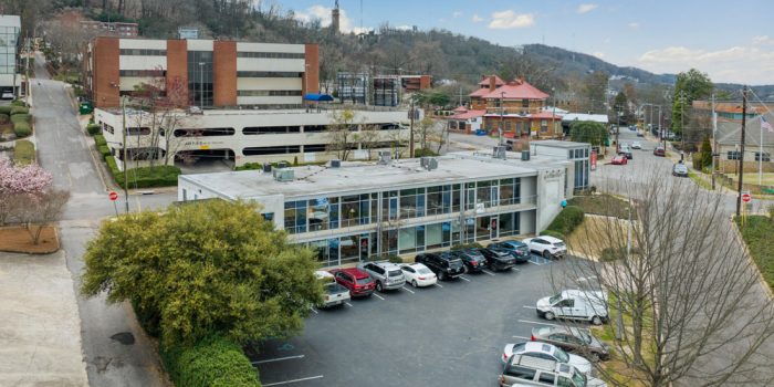 A Building With A Mountain In The Background