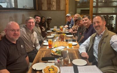 A Group Of People Sitting At A Table In A Restaurant
