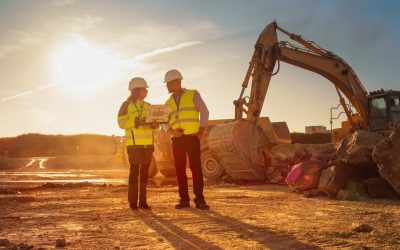 Two Project Managers Work Together On A Commercial Development Job Site, With Help From Alabama Development Tax Credits.