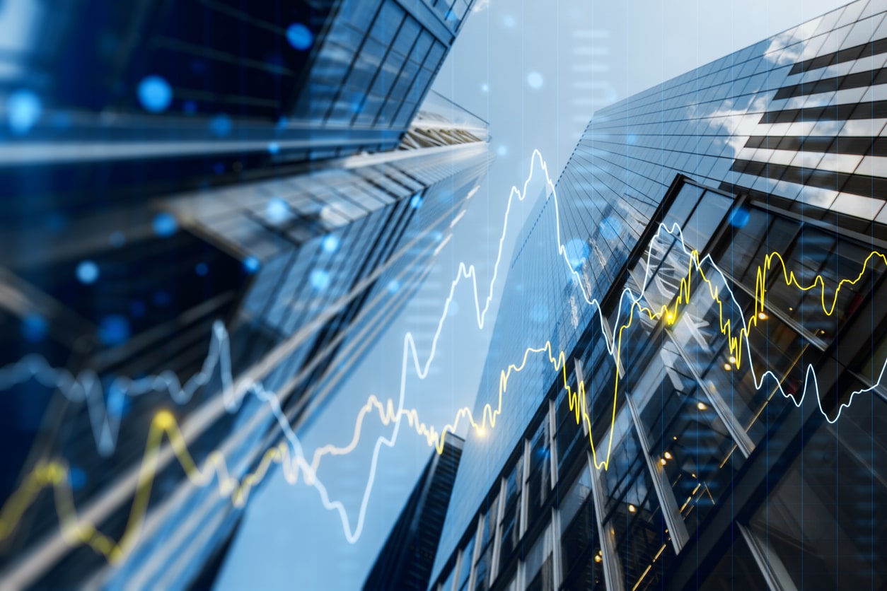 A view of downtown Birmingham is shown from below, with an investment portfolio graph overlaid to represent growth after relying on a real estate investment group.