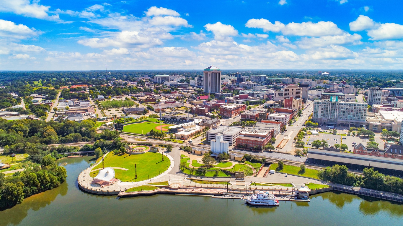 a large body of water with a city in the background