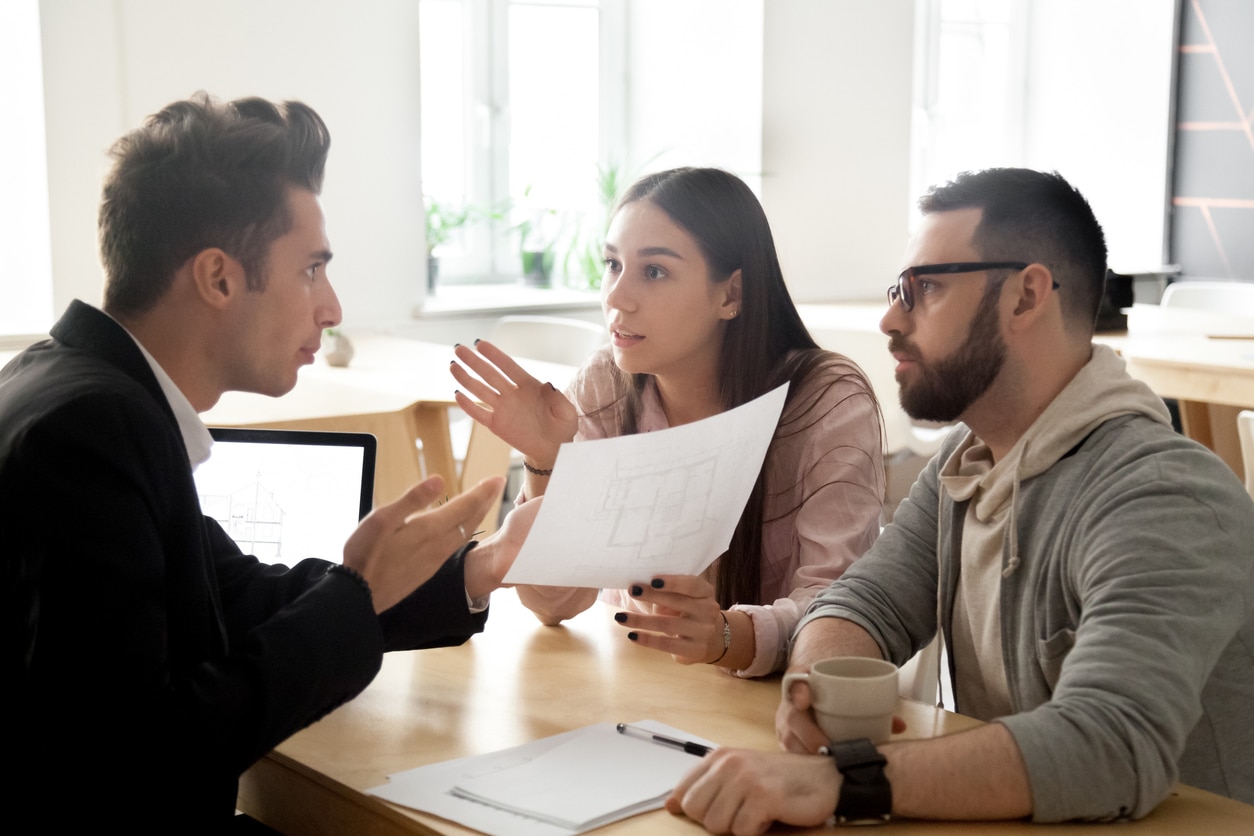 Tenants holding a lease meet with property management about a tenant dispute.